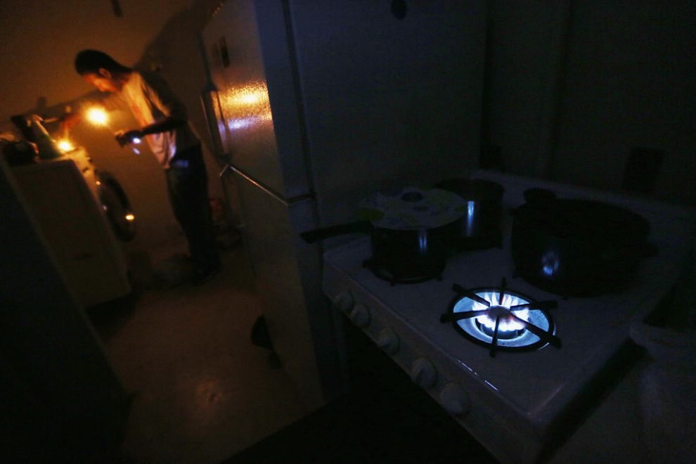 NEW YORK, NY - NOVEMBER 01: Geronimo Harrison stands in his apartment lit with candles and without power or water as the gas stove burns for heat in the Jacob Riis housing projects in Manhattan's East Village on November 1, 2012 in New York, United States. The residents of the 11th-floor apartment are using cooking gas for heat, must walk up and down eleven flights of dark stairs daily and have received virtually no governmental assistance since the storm struck. Residents of all the East Village housing projects have been without power and many without water since Superstorm Sandy hit, which flooded some of the housing projects.