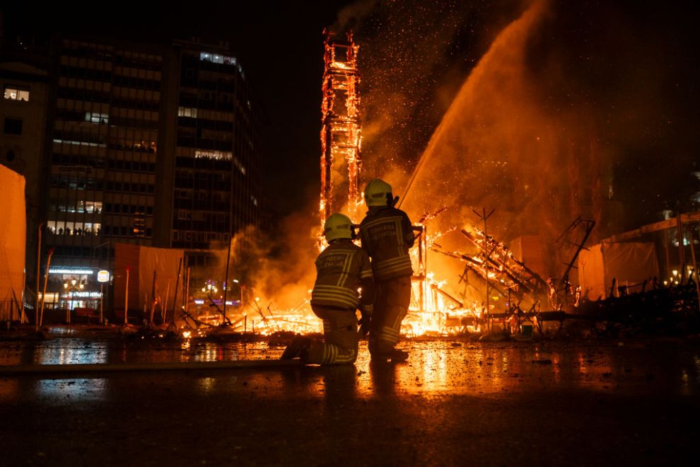VALENCIA VALENCIAN COMMUNITY, SPAIN - MARCH 19: Two firemen extinguish the 'Crema' of the Falla del Ayuntamiento, on 19 March, 2025 in Valencia, Valencian Community, Spain. The 'crema' closes today, on St. Joseph's Day, the Fallas 2025 in the city of Valencia and in the rest of the towns of the Valencian Community that celebrate them, both in this province and in the provinces of Castellon and Alicante. With this act, the last of the official program of these celebrations, the fire has consumed during the traditional 'Nit de la Crema', the big and children's monuments falleros planted in the Valencian capital and the rest of populations.